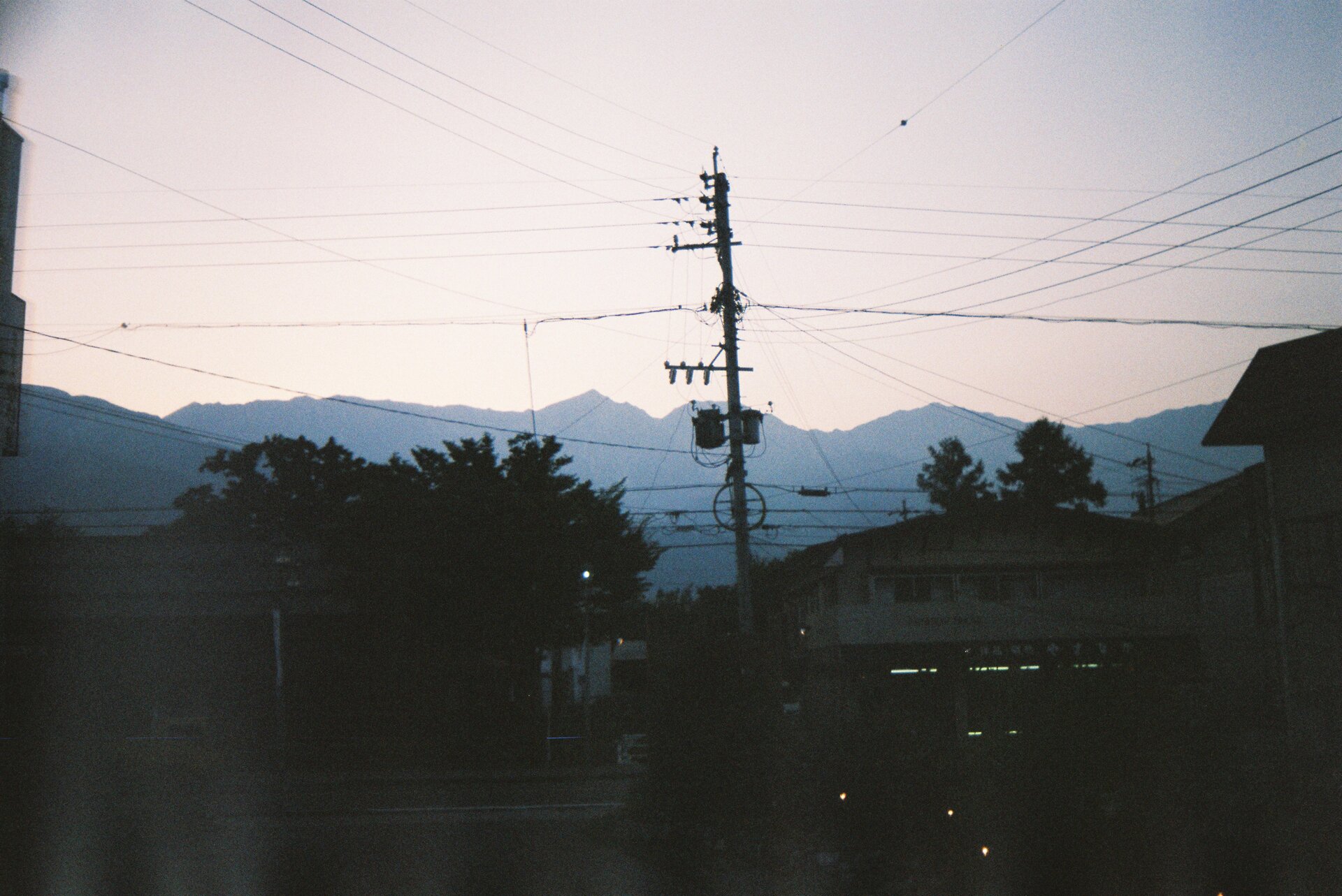 Overhead power lines against sky with electrical infrastructure